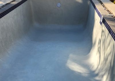 Concrete pool renovations completed with a grey interior finish.